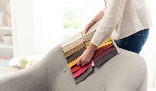 Professional decorator choosing the best upholstery for the armchair
